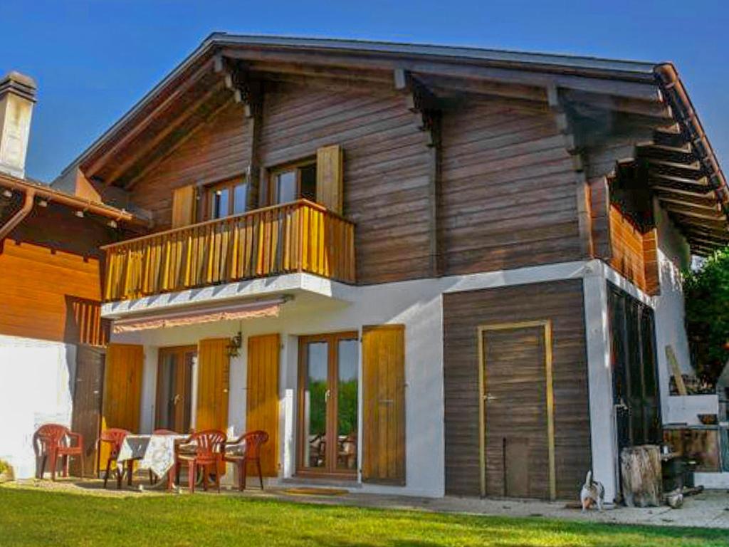a large wooden house with a balcony and a yard at Chalet Praline by Interhome in Icogne