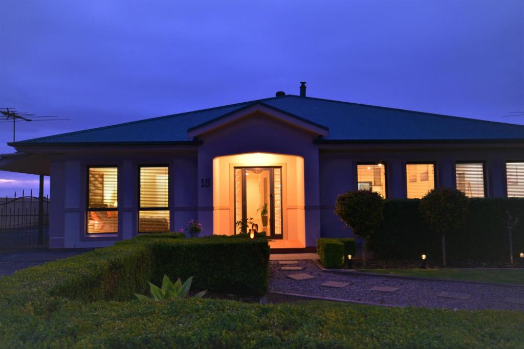 a house with its lights on in the evening at Stan Breeze: Elegant Family Retreat in Stansbury