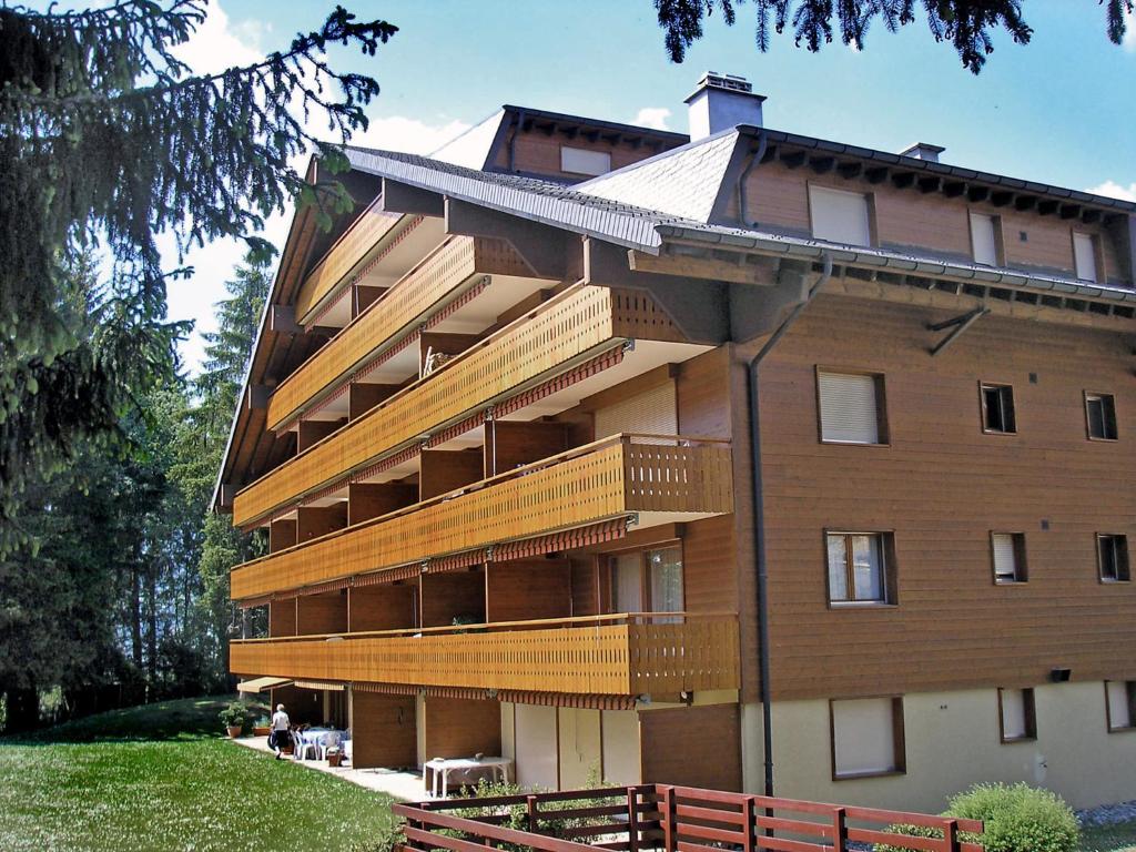 a building with wooden balconies on the side of it at Apartment Azurite 12 by Interhome in Villars-sur-Ollon