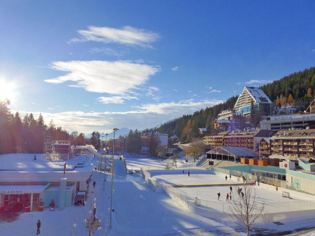 a town with a ski slope in the snow at Apartment Farinet B 21 by Interhome in Crans-Montana