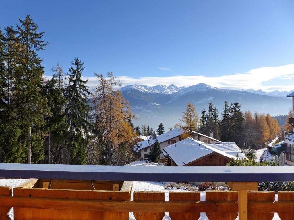 a view from the deck of a house in the mountains at Apartment Résidence Le Chalet 5 by Interhome in Crans-Montana