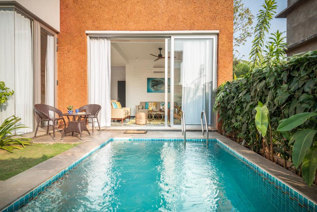 a swimming pool in the backyard of a house at La Risa by The Blue Kite - 2 BHK Villas near Vagator Beach, Private Pool with Kitchen, Balcony, Security in Vagator