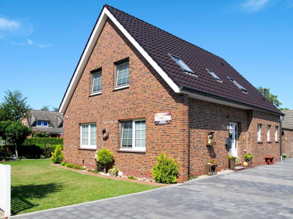 a red brick house with a black roof at Apartment Hannelore-1 by Interhome in Bübbens
