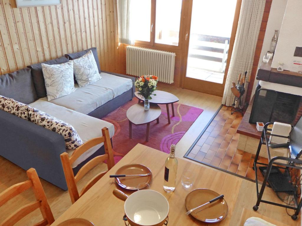 Apartment Centaure-3 by Interhome في Les Rasses: غرفة معيشة مع أريكة وطاولة