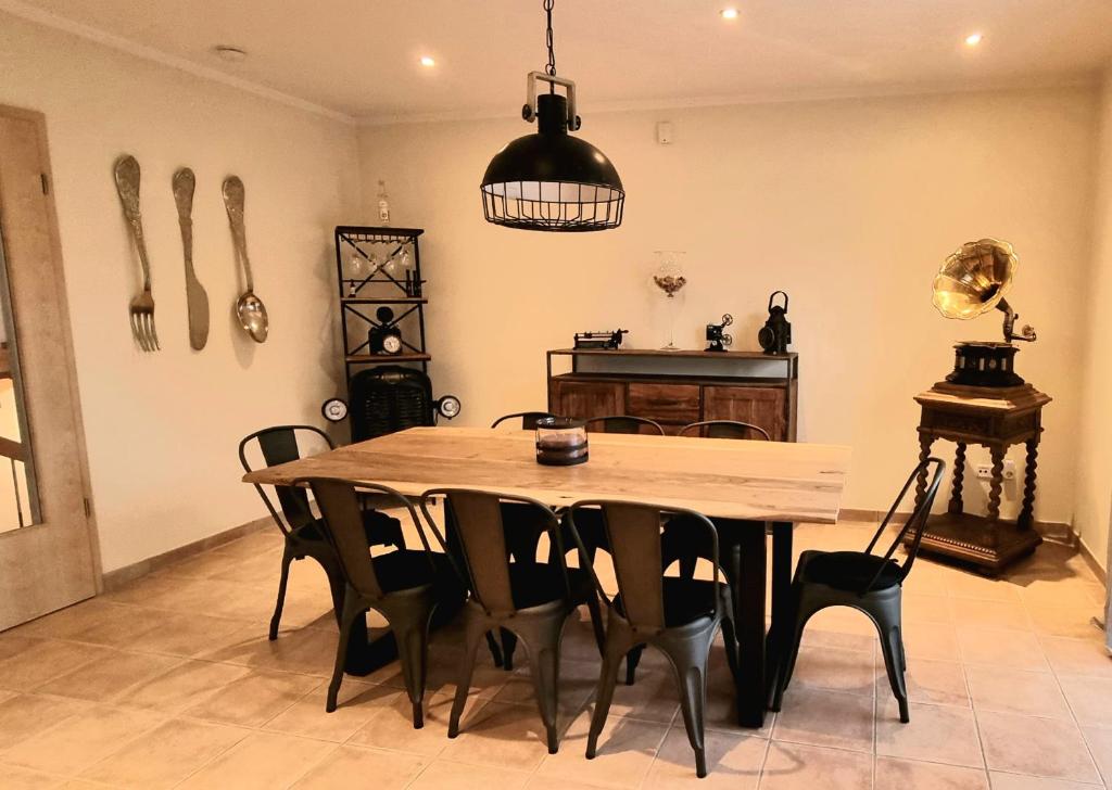 a dining room with a wooden table and chairs at Ferienhaus Antiquarius in Bendorf