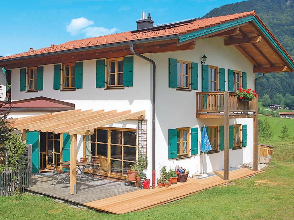 una grande casa bianca con portico e terrazza di Holiday Home Maiergschwendt by Interhome a Ruhpolding