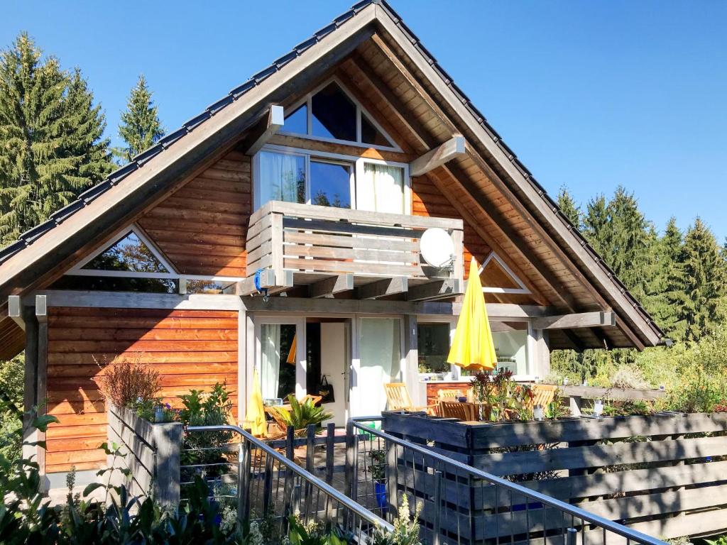 a log home with a balcony and a deck at Chalet Christine by Interhome in Molberting