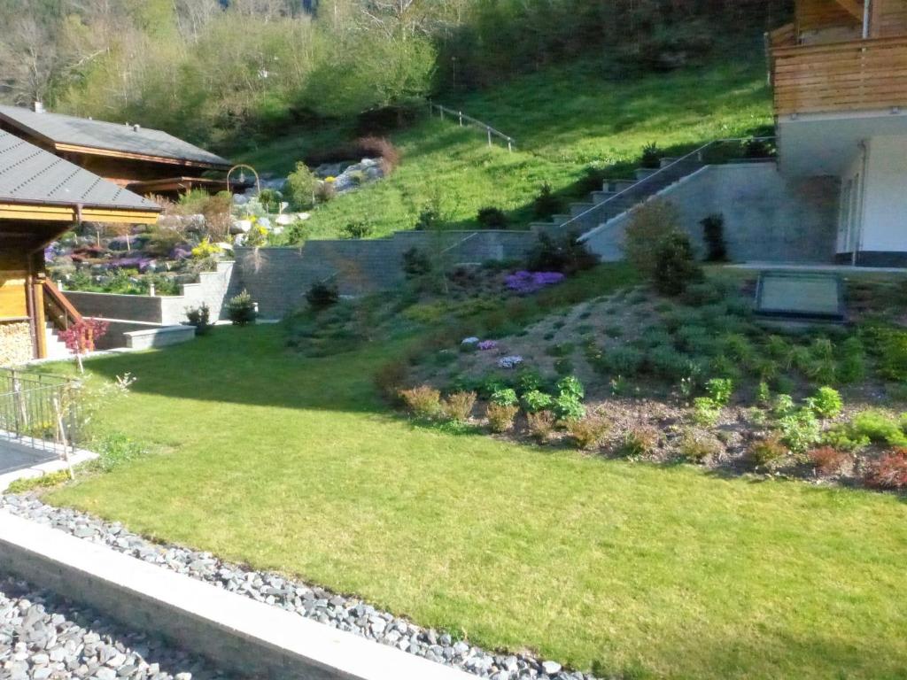 a garden on the side of a house at Apartment Chalet Schwendihus-11 by Interhome in Grindelwald
