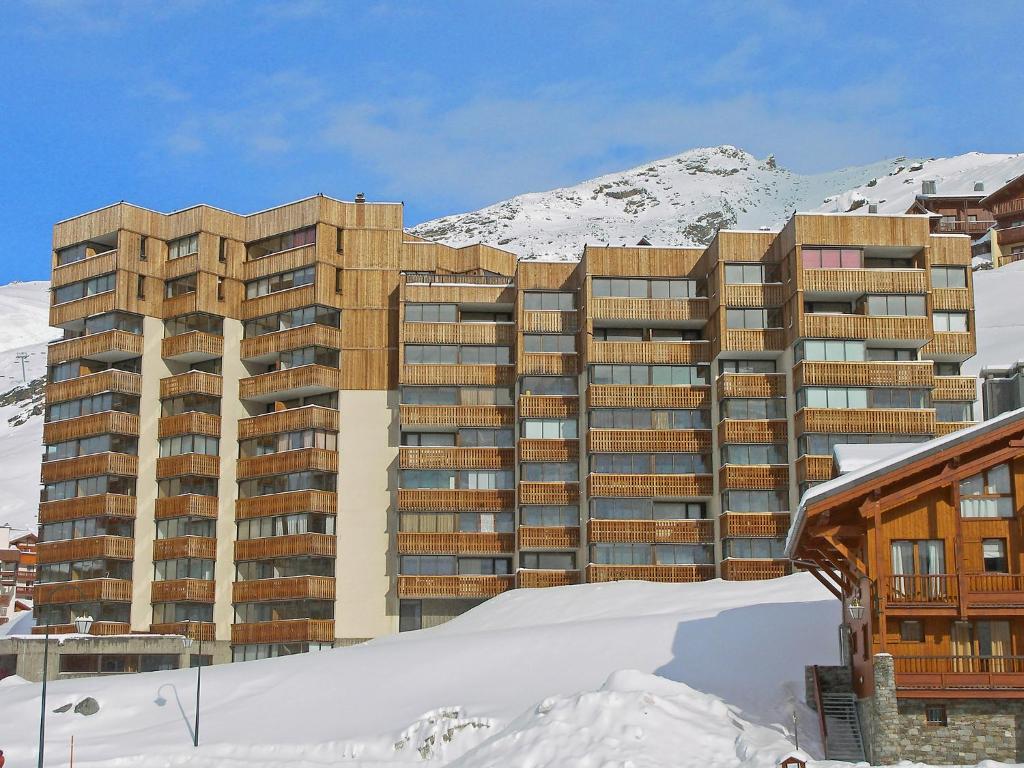 a building in the snow in front of a mountain at Apartment Le Sérac-3 by Interhome in Val Thorens