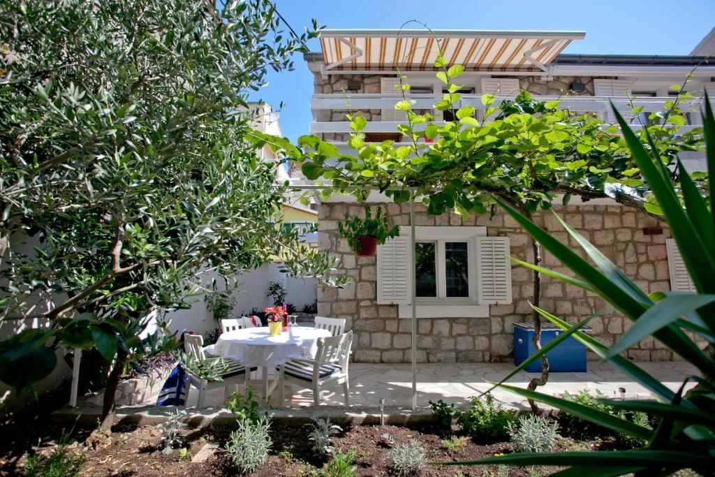 a patio with a table and chairs in front of a building at Apartment Sun & Sea in Split