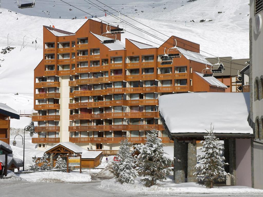 a large building in the snow with snow on it at Apartment Le Lac du Lou-3 by Interhome in Val Thorens