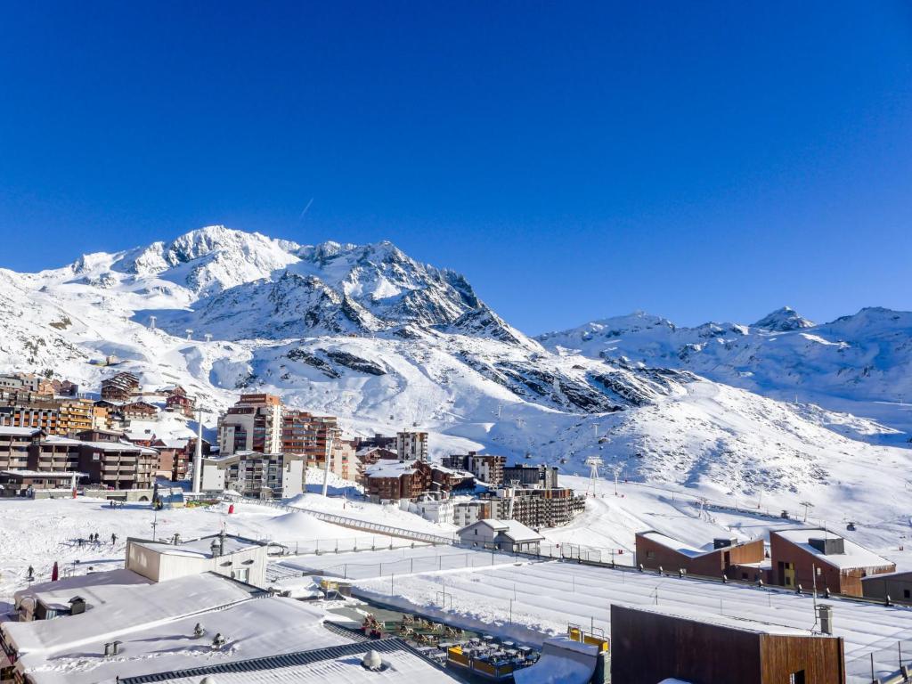 a city with a snowy mountain in the background at Apartment Arcelle-11 by Interhome in Val Thorens