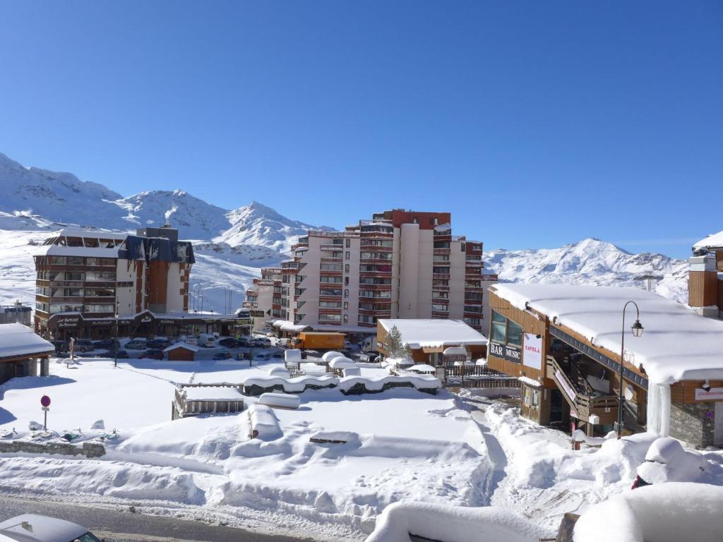 a city covered in snow with buildings and mountains at Apartment Les Glaciers by Interhome in Val Thorens