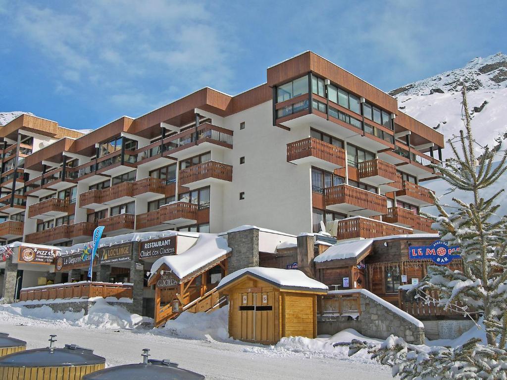 a large building with snow on the ground in front of it at Apartment Les Glaciers by Interhome in Val Thorens