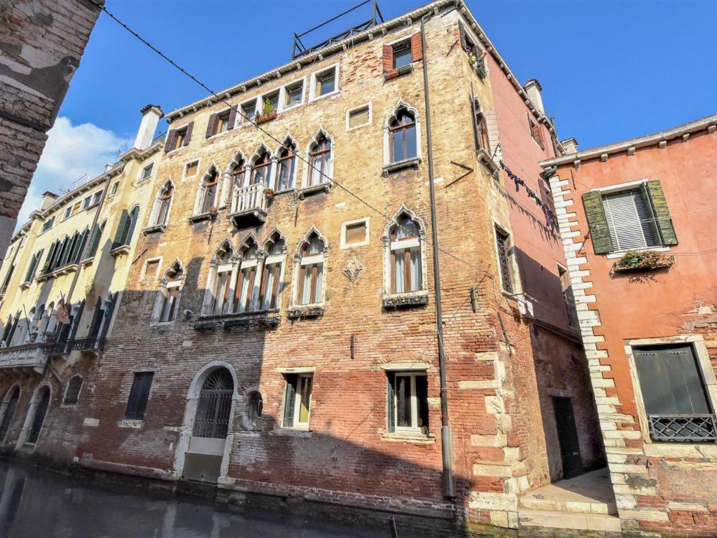 an old brick building with a lot of windows at Apartment Sotoportego Venier by Interhome in Venice