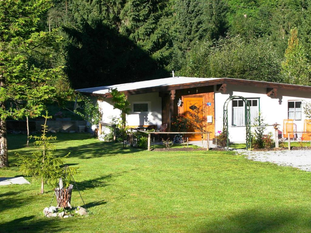 una pequeña casa blanca con un patio delante en Holiday Home Ferienhaus Keil by Interhome en Bad Gastein