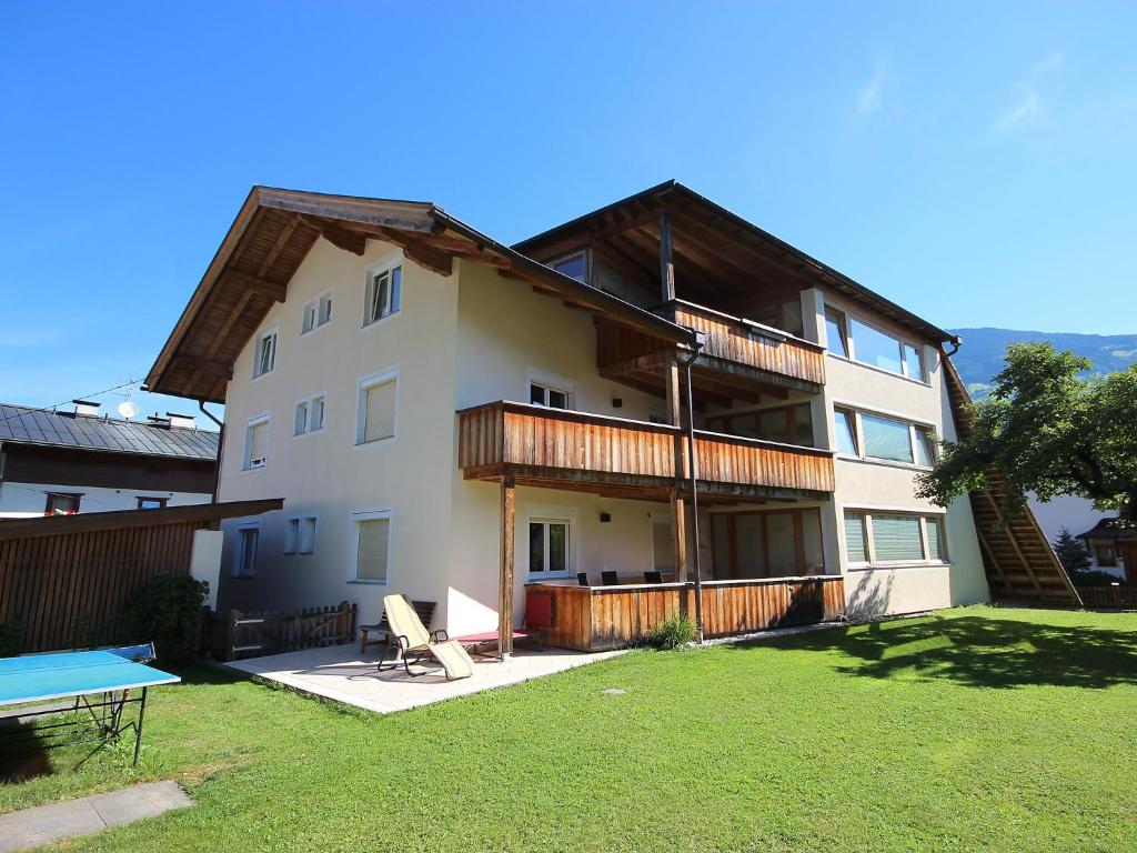 a large white building with a picnic table in a yard at Apartment Gerda-2 by Interhome in Ried im Zillertal