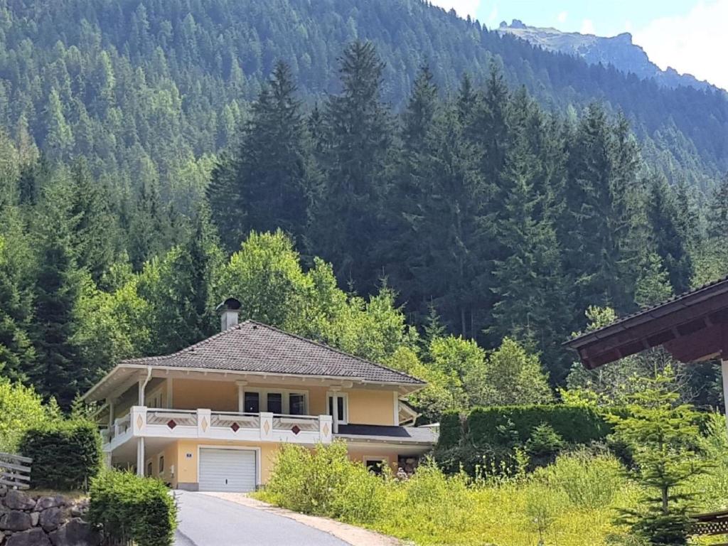 a house with a garage in front of a mountain at Holiday Home Steindlwald by Interhome in Untertauern