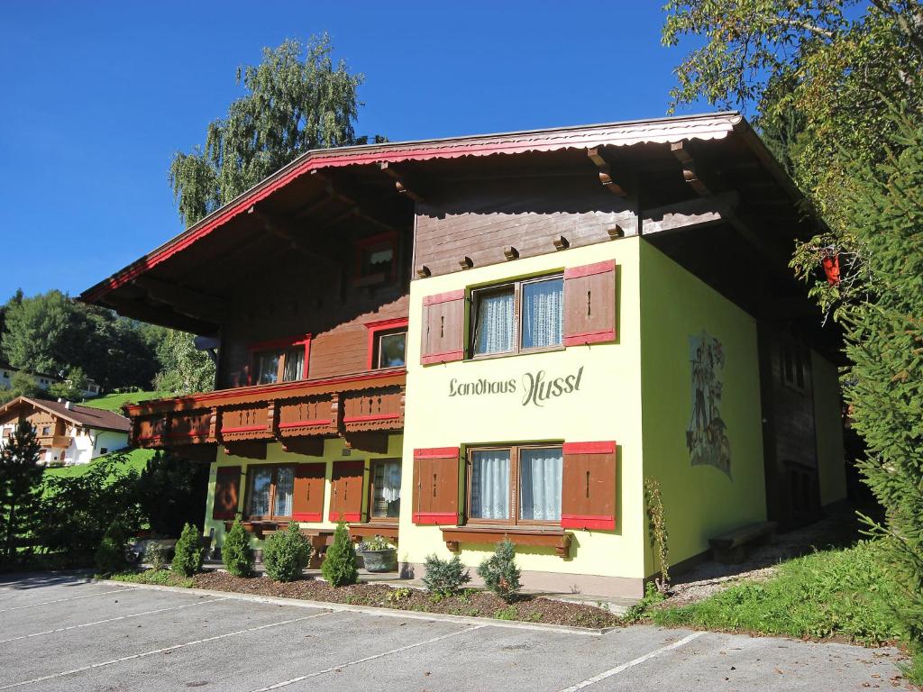 a building with red and green doors on it at Holiday Home Hussl by Interhome in Fügenberg