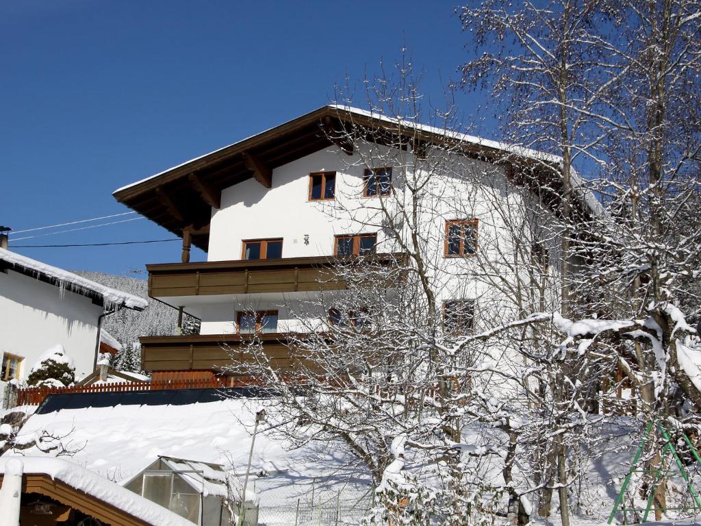 a white building with snow on it at Apartment Straif by Interhome in Kirchberg in Tirol