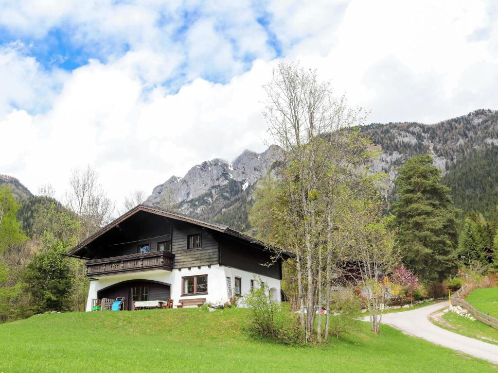 a house on a hill with mountains in the background at Holiday Home Diana by Interhome in Weißenbach