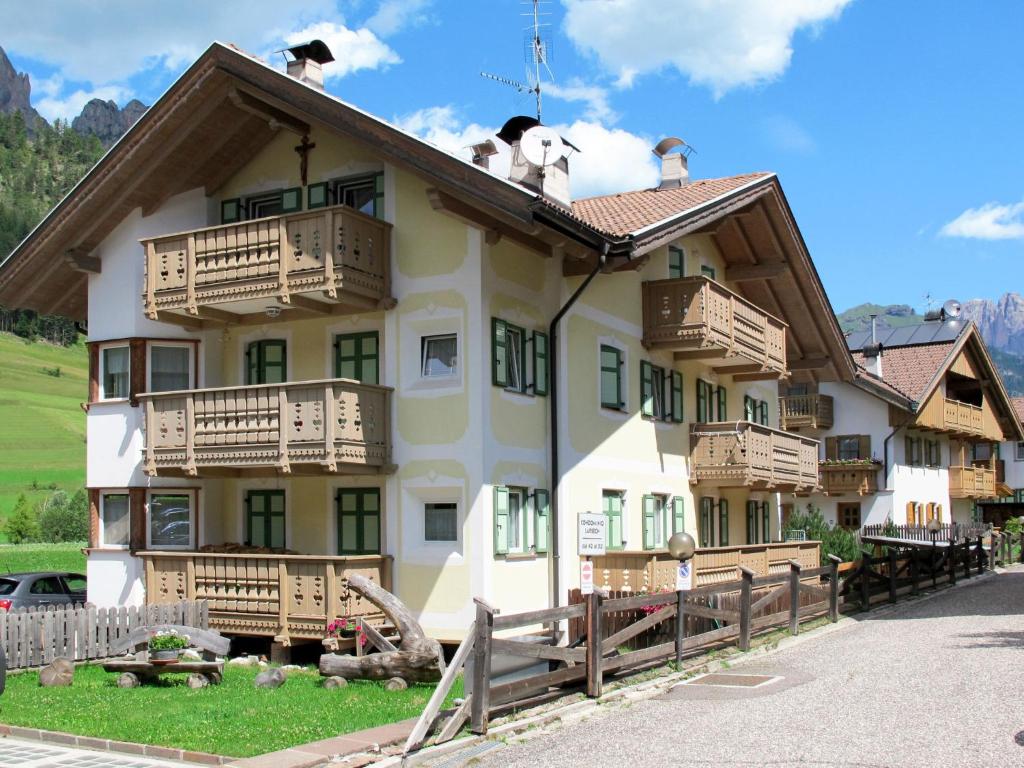a large building with wooden balconies on top of it at Apartment Maura-1 by Interhome in Pozza di Fassa