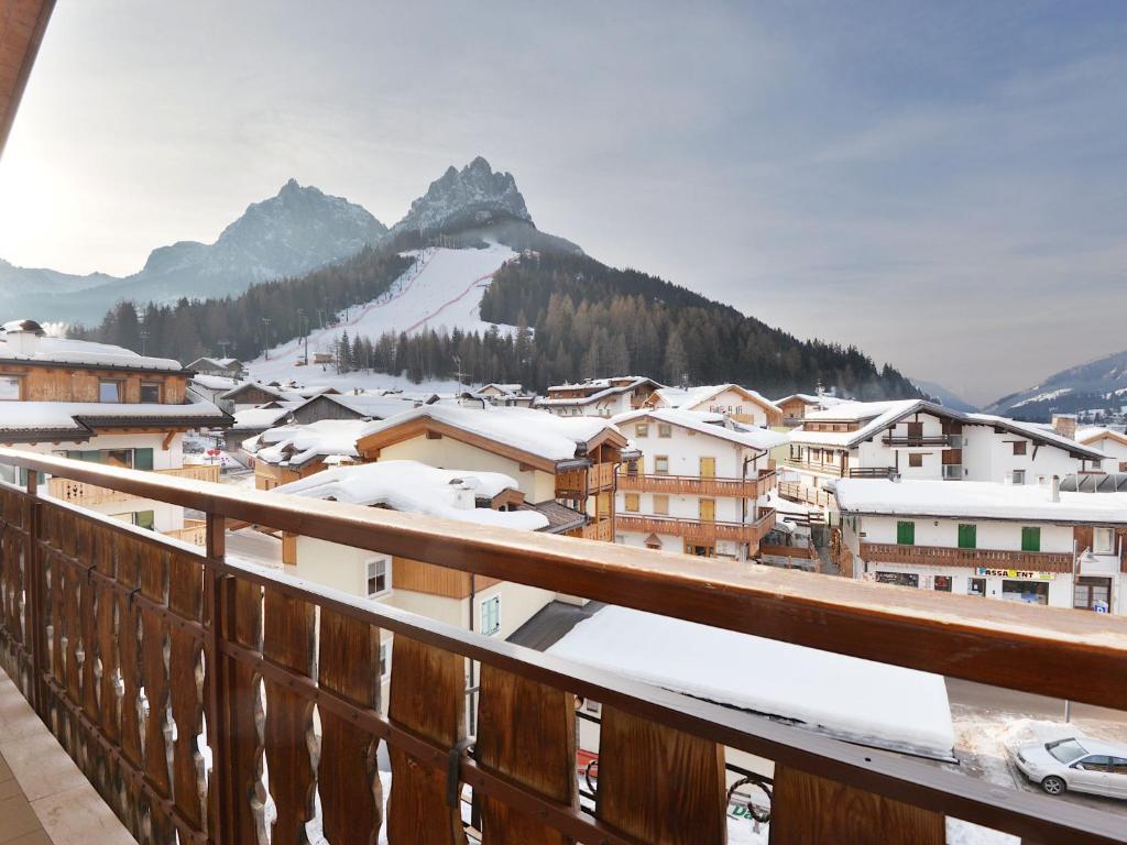 a view from a balcony of a town in the snow at Apartment Florian Pia by Interhome in Pozza di Fassa