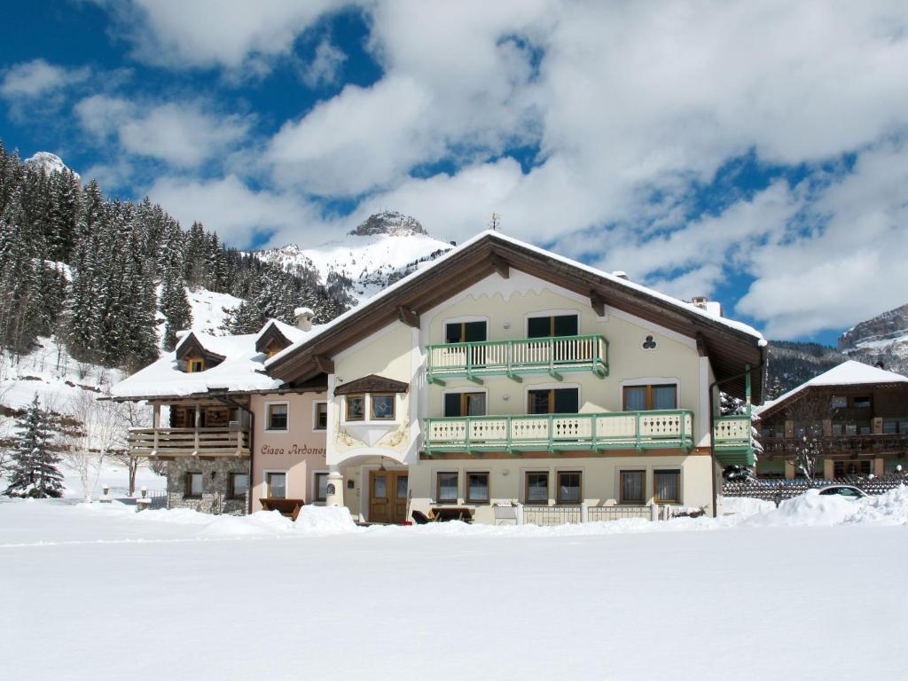 a large building in the snow in front of a mountain at Apartment Ardoney-1 by Interhome in Campitello