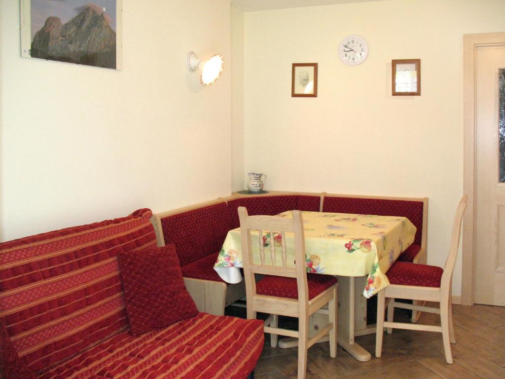 a dining room with a table and chairs and a bench at Apartment Spinel by Interhome in Campitello