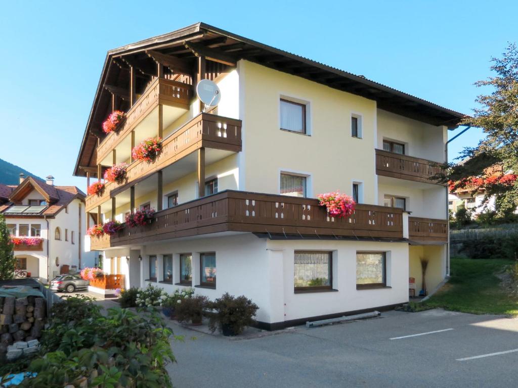 een gebouw met balkons en bloemen erop bij Apartment Haupthaus Schönblick by Interhome in San Valentino alla Muta