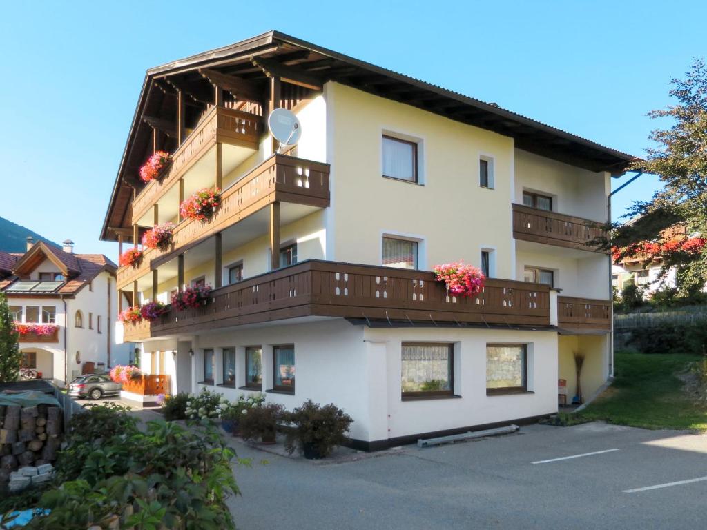 a building with balconies and flowers on it at Apartment Haupthaus Schönblick by Interhome in San Valentino alla Muta