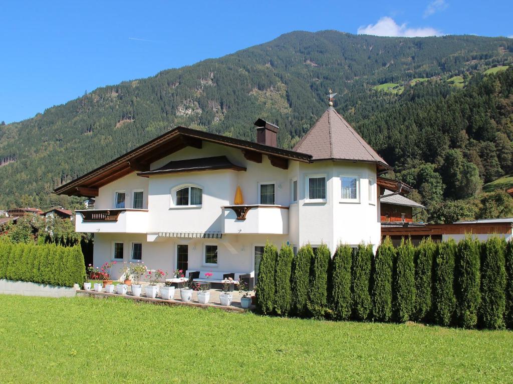 a large white house in front of a mountain at Apartment Monika-2 by Interhome in Gattererberg