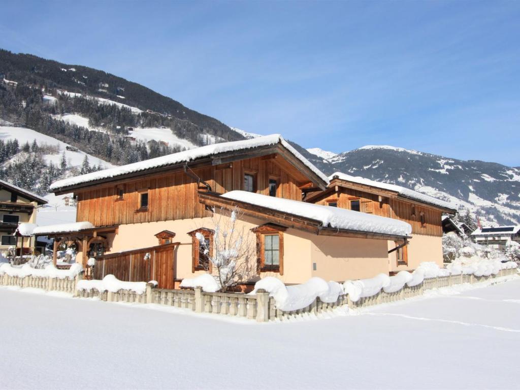 a large wooden building with snow on the ground at Holiday Home Schwendau-1 by Interhome in Hippach