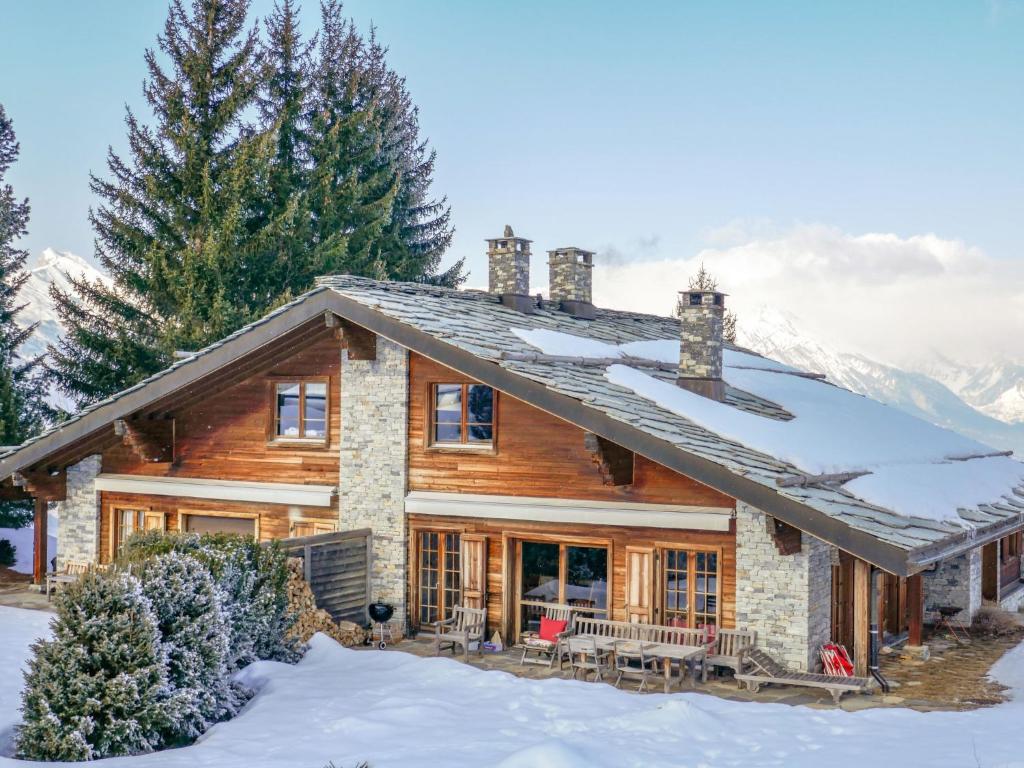 a log home with snow on the ground at Holiday Home Les Clèves by Interhome in Nendaz