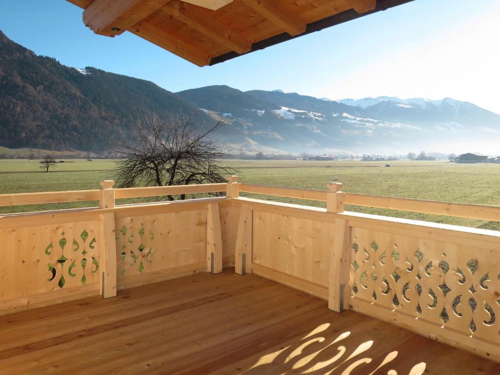 a wooden deck with a view of the mountains at Apartment Zillertalblick - FGZ230 by Interhome in Strass im Zillertal