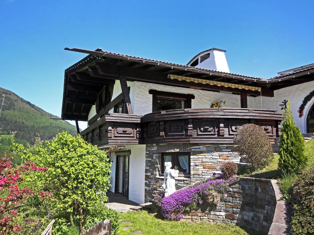 a stone house with a statue in front of it at Apartment Lener-2 by Interhome in Matrei am Brenner