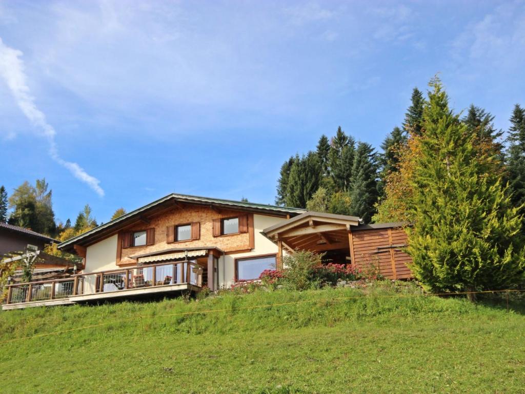 a house on a hill with trees in the background at Chalet The Schatzie by Interhome in Egg