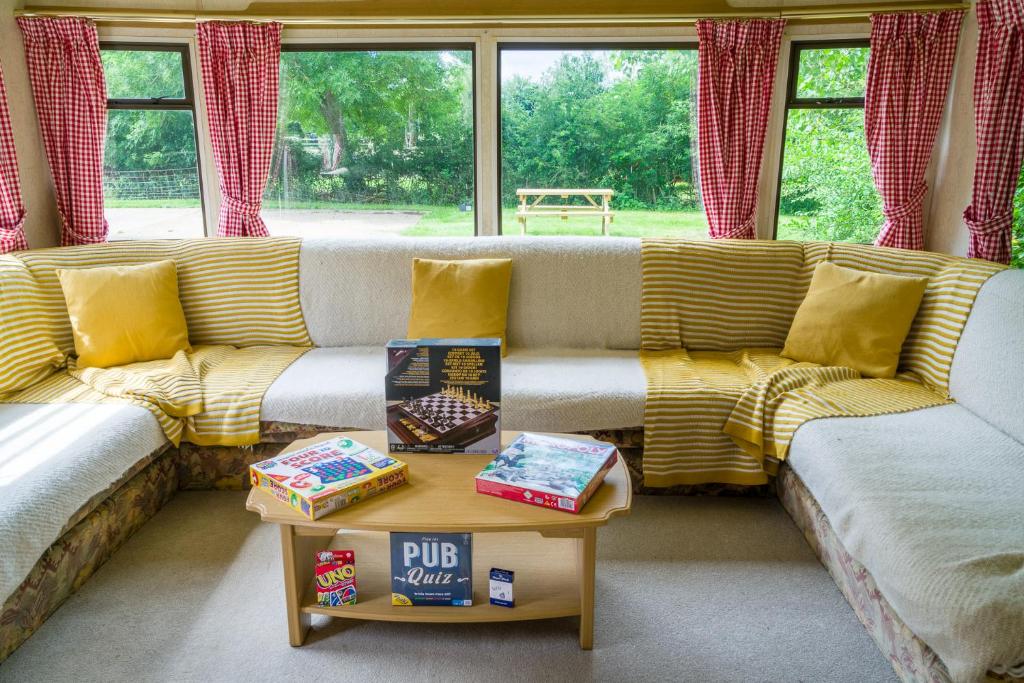 a living room with a couch and a table at Tadpole Retreat at Lower Fields Farm in Napton on the Hill