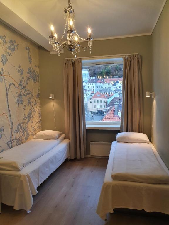 a bedroom with two beds and a large window at City Hostel Bergen in Bergen