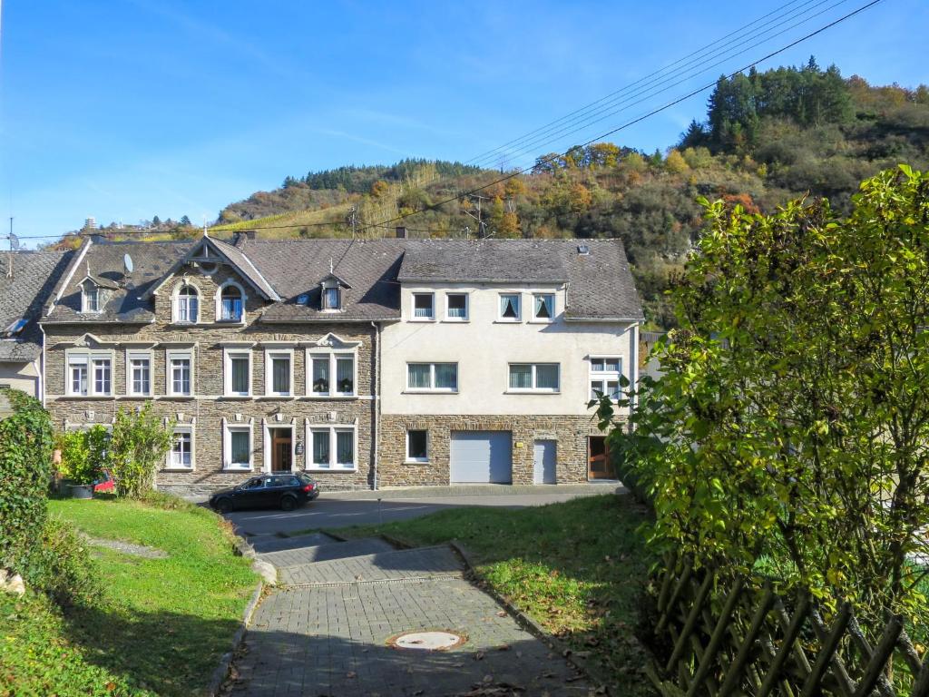 a large house with a car parked in the driveway at Apartment Weingut Krempel by Interhome in Traben-Trarbach