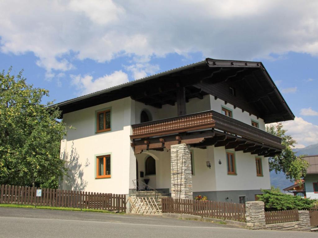 a small white house with a black roof at Holiday Home Chalet Alpin by Interhome in Kaprun
