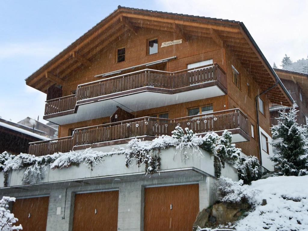 a apartment building with a balcony with snow on it at Apartment Mountain Lake Panorama by Interhome in Sundlauenen