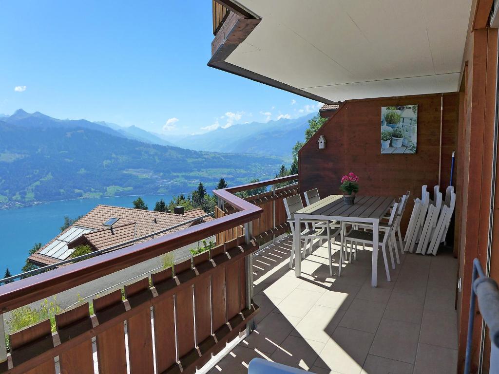 a balcony of a house with a table and chairs at Apartment Mountain Lake Panorama by Interhome in Sundlauenen