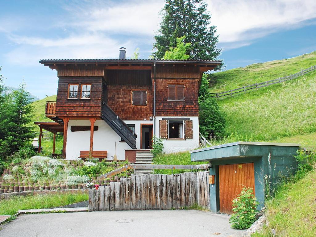 a house on a hill with a fence in front of it at Apartment Montana by Interhome in Langwies