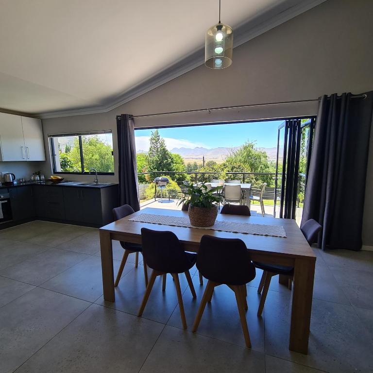 a kitchen and dining room with a table and chairs at Clarens Escape (Unit 3) in Clarens