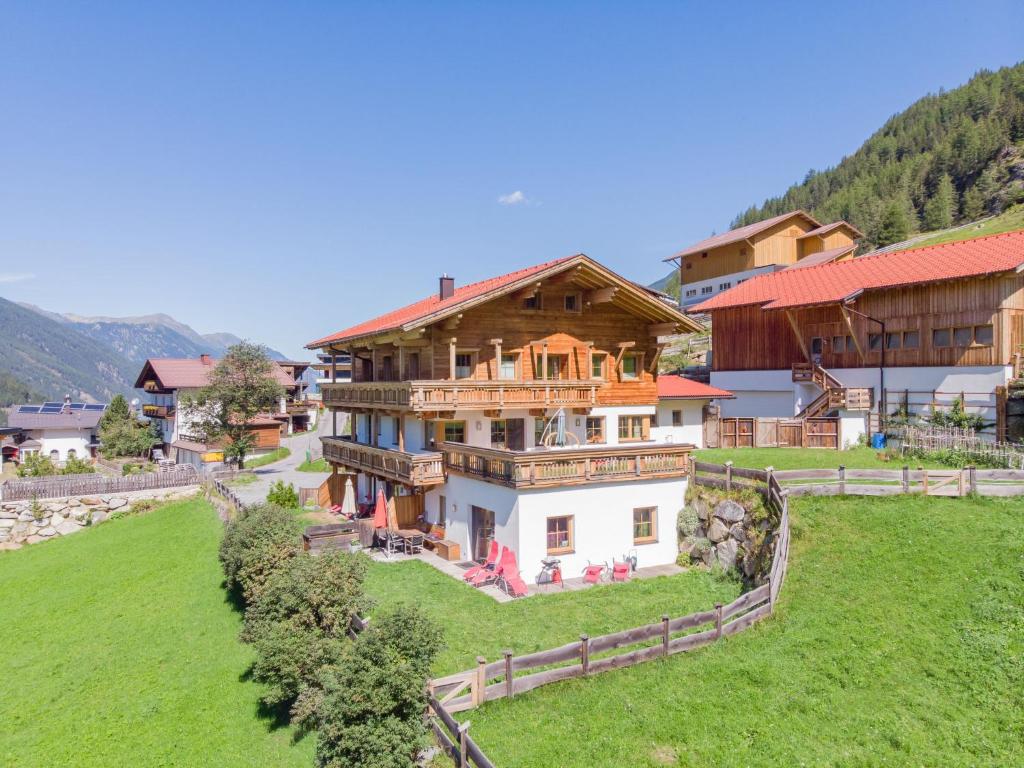 a large house on a hill with a green field at Apartment s' HimmelReich-1 by Interhome in Huben