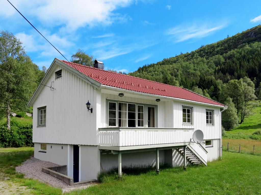 a white house with a red roof at Holiday Home Olavbu - SOW105 by Interhome in Åseral