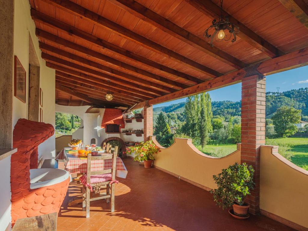 a patio with a table and a large window at Apartment Barbara by Interhome in Corsanico-Bargecchia