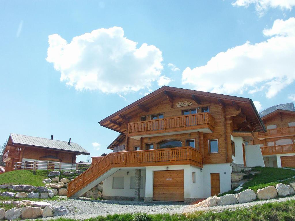 a large wooden house with a balcony on a hill at Chalet Annabel by Interhome in Anzère