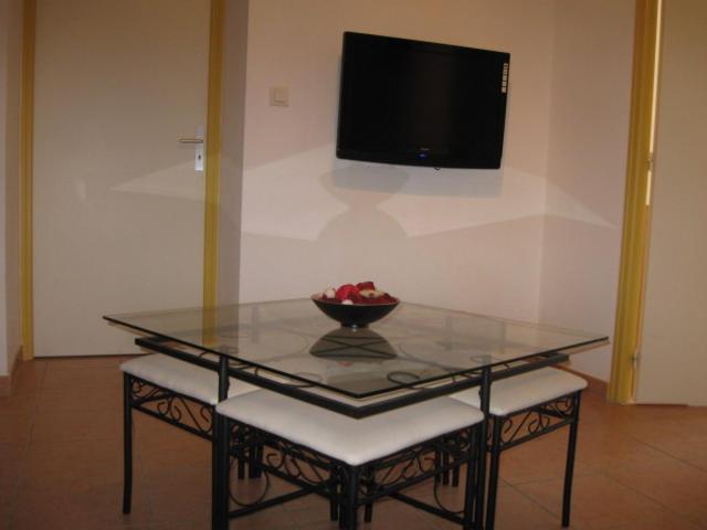 a glass table with a bowl of fruit on it at GITE DES FRANCISCAINS-Imiza in Canari